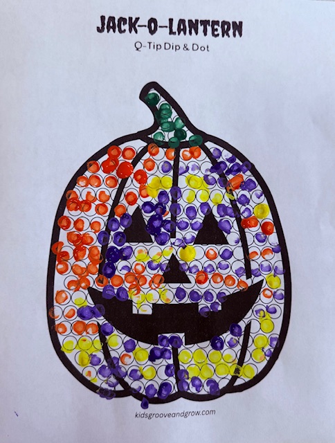 Completed Halloween Q-tip painting jack-o-lantern fine motor activity with colorful dots
